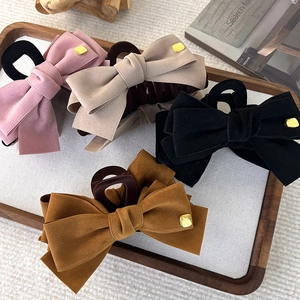 Retro velvet bow hair claws set in pink, beige, black, and caramel with gold metal accents