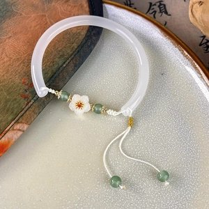 Detail of vintage Chinese flower bangle with white shell petal and green jade beads