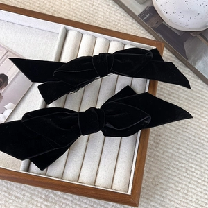 Set of two French vintage black velvet bow hair clips on a premium white padded display tray