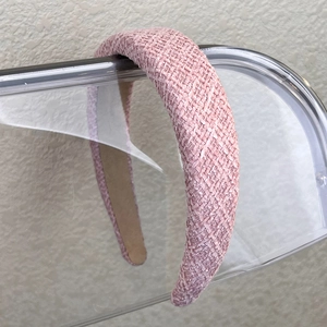 Close-up of pink tweed headband with thick woven texture and anti-slip lining detail