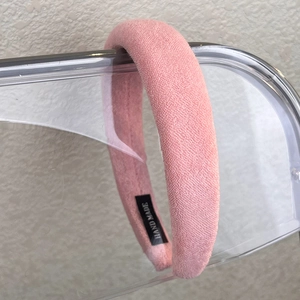 Detail of pink padded sponge headband with plush terry fabric and handmade woven label