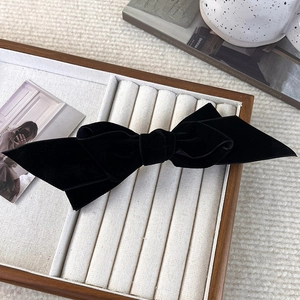 Detailed view of large black velvet bow hair clip with elegant double-layer design