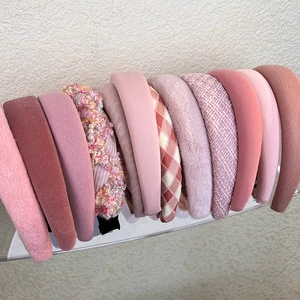Pink high-top padded headbands collection in plush, tweed, and knit styles for women