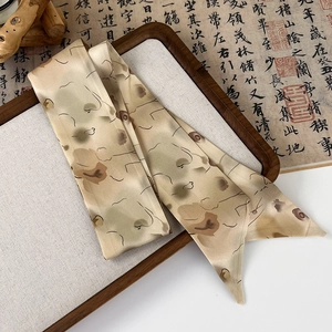 Close-up of vintage long silk hair ribbon with floral patterns on a traditional art background
