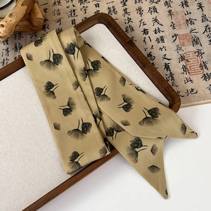 Detail of silk hair ribbon with ink wash floral pattern in mustard yellow satin