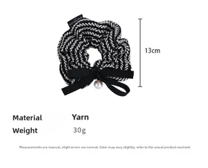 Detailed knit hair scrunchie with black bow, pearl pendant and 13cm diameter measure