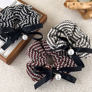 Three bow pearl hair scrunchies with herringbone knit pattern and ribbon detail