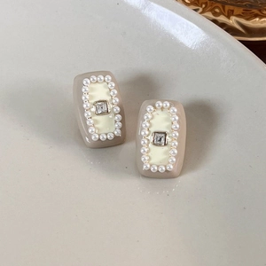 Detail of vintage French square stud earrings with cream resin, pearls and zircon