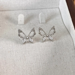 Macro view of silver butterfly earrings with sparkling marquise-cut cubic zirconia