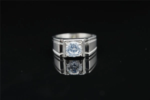 Detailed macro view of men's geometric silver steel ring with round brilliant moissanite