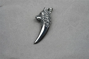 Detailed close-up of a silver punk wolf head and fang pendant with realistic fur texture