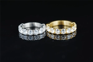 Macro shot of silver and gold eternity rings with round-cut moissanite in prong setting