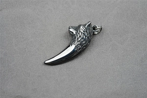 Close-up of a vintage titanium steel wolf head pendant with detailed silver metallic finish