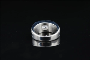 Detailed view of silver wide-band titanium steel ring with sparkling moissanite stone