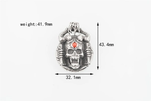 Detailed view of punk skull pendant with red gemstone and dimensions marking