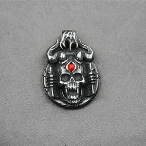 Punk gothic skull pendant with bull horns and red gemstone inlay on gray background
