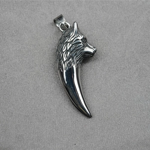 Polished silver stainless steel wolf head and tooth pendant with intricate metallic carving