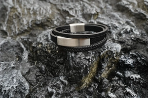 Detailed shot of multi-layer braided leather bracelet with brushed stainless steel clasp