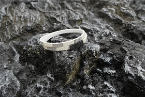 Close-up of double-layered white checkered leather bracelet with black magnetic clasp
