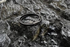 Detail of double-layer black leather bracelet with matte black magnetic metal clasp