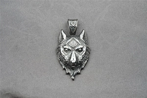 Detailed view of a vintage wolf head pendant with intricate fur texture and runes