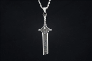 Detailed view of sword pendant with gothic warrior engraving and runic patterns