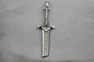 Detail view of a vintage silver sword pendant featuring a Viking warrior head and rune carvings