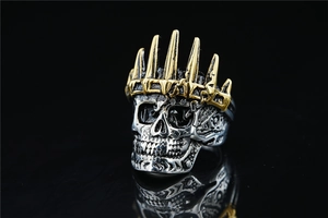 Macro shot of vintage skull ring with gold crown detail and oxidized steel finish