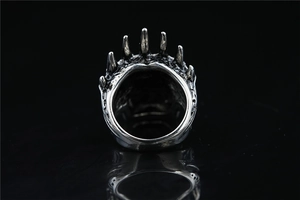 Macro detail of gothic crown skull ring with sharp silver spikes and dark punk design