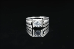 Macro shot of silver moissanite ring with square setting and ribbed metal details