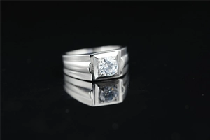 Macro shot of men's silver moissanite ring with square setting and side groove details