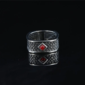 Vintage silver-tone wide ring with red gemstone and intricate woven texture patterns