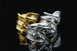 Macro shot of retro feather ring detail with intricate metal textures and silver finish