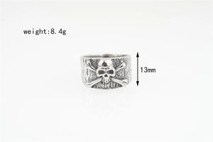 Close-up of vintage silver skull ring with textured band detail and dimensions 13mm