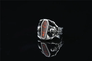 Macro shot of gothic coffin ring with red mystical symbols and skeleton rib detail