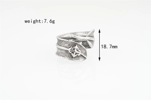 Macro shot of vintage feather ring detail with cross motif and 18.7mm size dimension