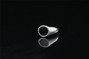 Macro detail of minimalist silver ring with polished black enamel inlay on dark background
