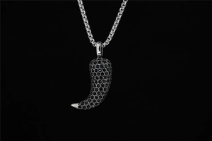 Detailed view of hip hop chili pendant necklace with black micro-pave stones on silver chain
