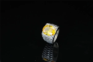 Macro shot of silver titanium steel ring featuring faceted oval yellow gemstone and grooved shank