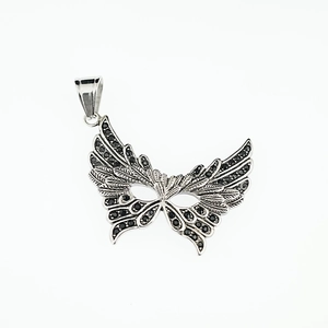 Vintage mask and butterfly wing pendant necklace with black rhinestones on white background