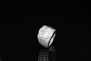Macro shot of silver titanium ring with oval white gemstone and ribbed texture design
