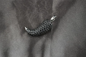 Macro detail of a 3D chili pendant necklace featuring full black crystal pave setting
