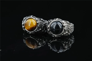 Detailed view of vintage rings featuring bat motifs and inlaid gemstone beads