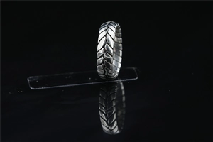 Macro shot of industrial tire pattern ring with vintage oxidized silver finish texture