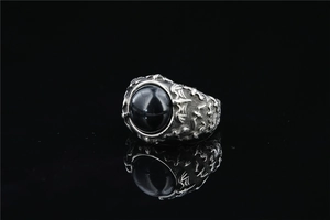 Macro shot of retro bat ring with black gemstone and intricate vintage carvings