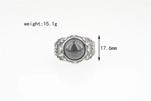 Detailed view of vintage bat ring featuring a grey gemstone and ornate engraved patterns