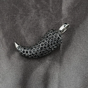 Hip hop style silver chili pendant necklace with black pavé crystals on silk background