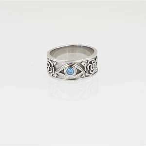 Vintage steel ring with Eye of Horus and rose carvings featuring a blue zircon center