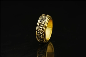 Macro shot of gold Eye of Horus ring with embossed details and vintage finish