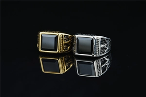 Macro view of vintage Masonic rings featuring square black resin stone and Egyptian carvings